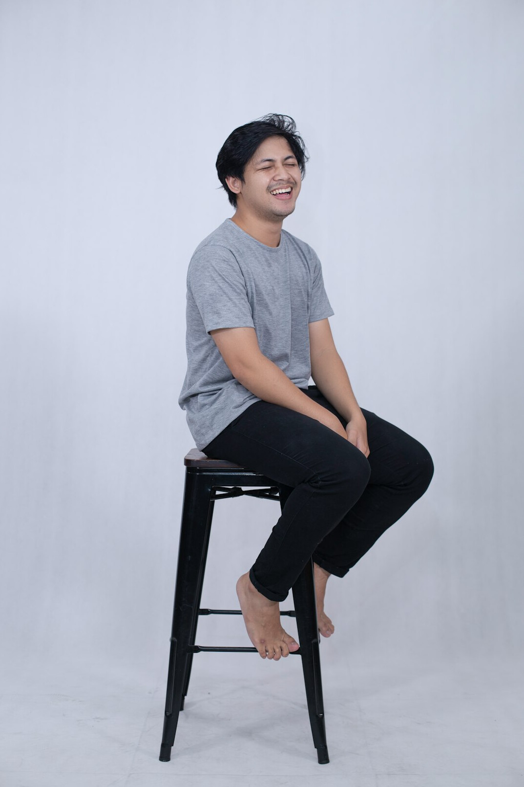 Studio portrait of a smiling young Singaporean man
