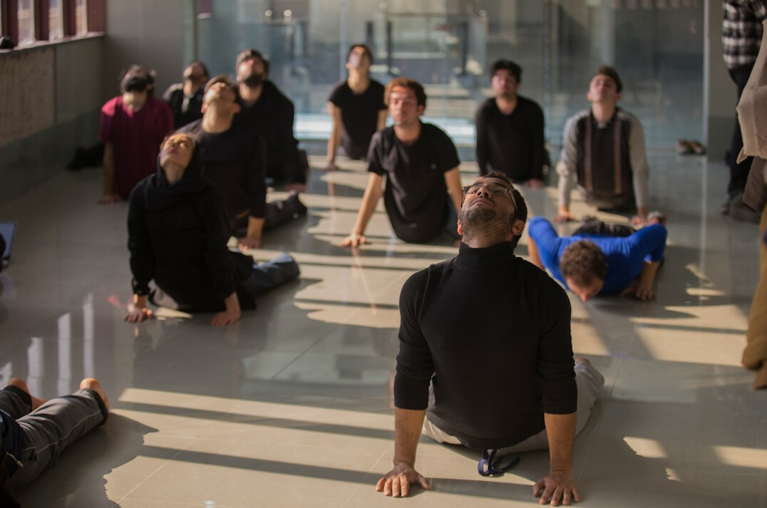 Instructor leading a wellness workshop with attentive participants around a table