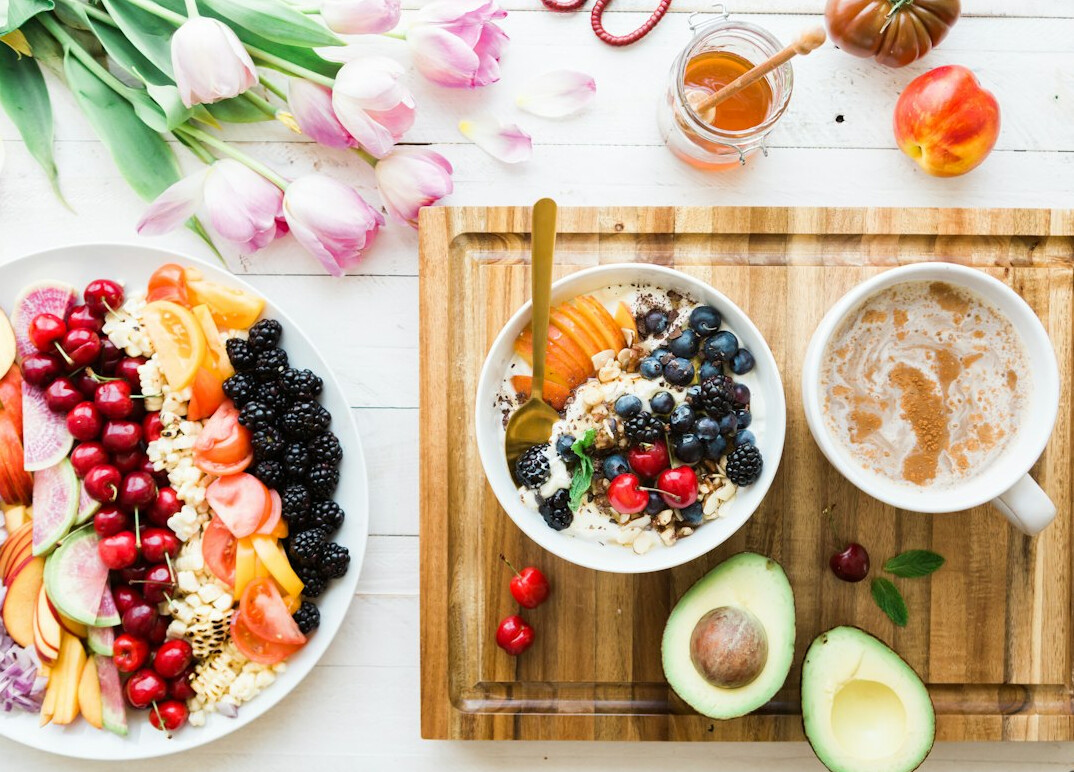 Nutrition consultant reviewing a diet plan with a client at a bright desk