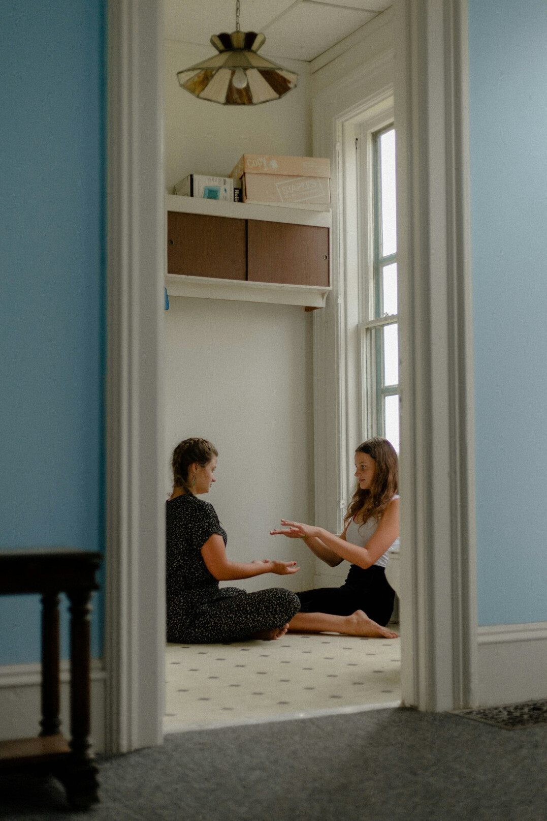 Health coach guiding a client through a wellness assessment in a bright studio